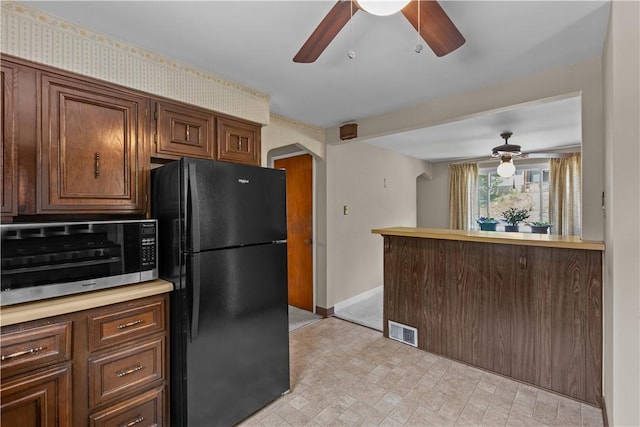 1031 Stratmore St, Ingram, PA 15205 - kitchen featuring freestanding refrigerator, a ceiling fan, stainless steel microwave, and light countertops