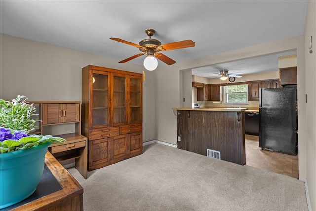 1031 Stratmore St, Ingram, PA 15205 - kitchen featuring freestanding refrigerator, a peninsula, a ceiling fan, light countertops, and light carpet