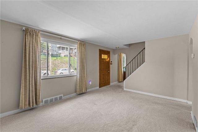 1031 Stratmore St, Ingram, PA 15205 - foyer entrance featuring arched walkways, carpet floors, and stairway