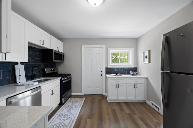 1822 Plainview Ave, Brookline, PA 15226 - kitchen featuring stainless steel appliances, a baseboard heating unit, backsplash, and white cabinets