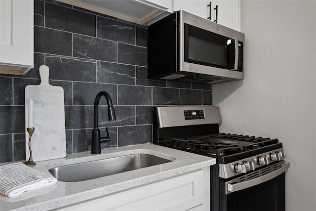 1822 Plainview Ave, Brookline, PA 15226 - kitchen featuring appliances with stainless steel finishes, tasteful backsplash, white cabinetry, and light stone counters
