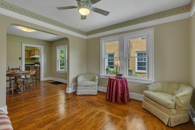 1586 Jackson St, Aliquippa, PA 15001 - living area featuring arched walkways, a ceiling fan, and wood finished floors