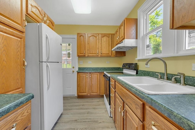 1586 Jackson St, Aliquippa, PA 15001 - kitchen featuring range with electric stovetop, freestanding refrigerator, under cabinet range hood, light wood-type flooring, and healthy amount of natural light