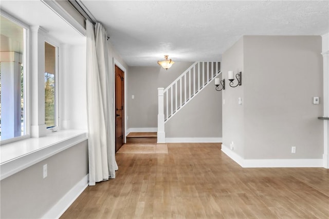 626 Solomon Temple Rd, Unity Twp, PA 15650 - empty room featuring light wood finished floors and stairs
