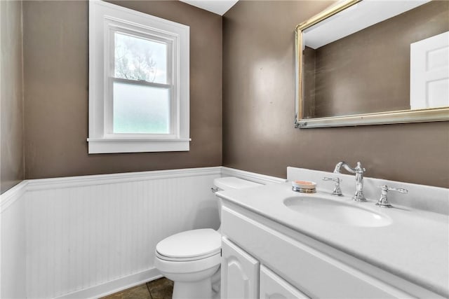 626 Solomon Temple Rd, Unity Twp, PA 15650 - half bathroom with a wainscoted wall, vanity, and tile patterned flooring