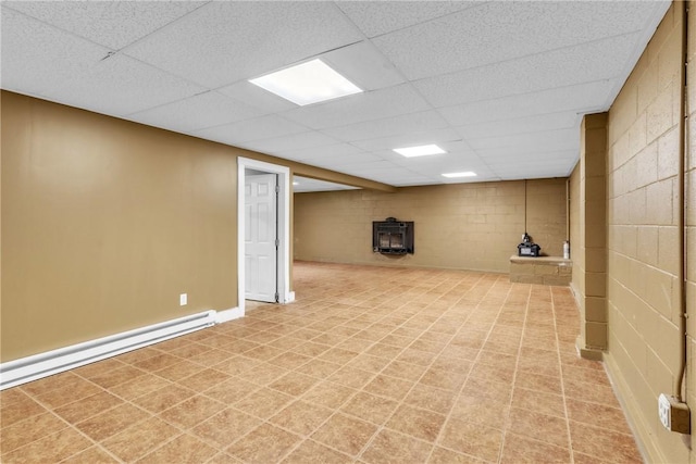 626 Solomon Temple Rd, Unity Twp, PA 15650 - finished basement featuring a wood stove, a drop ceiling, concrete block wall, and baseboard heating