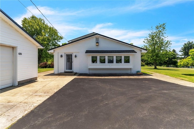 626 Solomon Temple Rd, Unity Twp, PA 15650 - view of front of home featuring brick siding, a front lawn, and an outbuilding