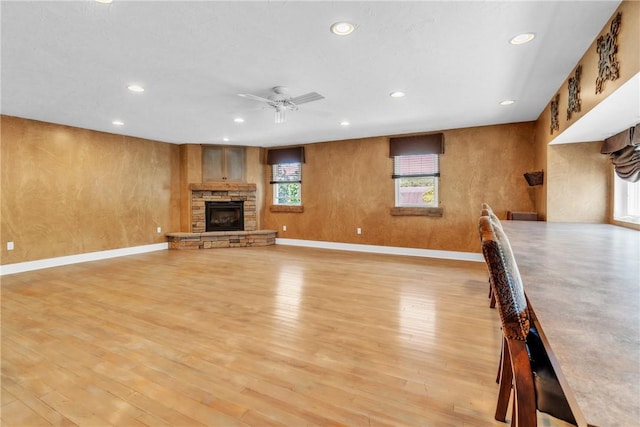 626 Solomon Temple Rd, Unity Twp, PA 15650 - unfurnished living room featuring a fireplace, light wood-type flooring, a ceiling fan, and recessed lighting