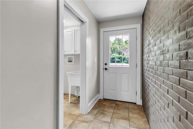 626 Solomon Temple Rd, Unity Twp, PA 15650 - doorway to outside featuring brick wall and light stone finish flooring