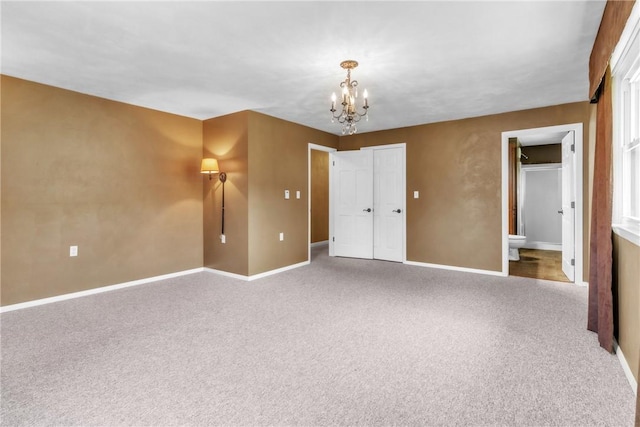 626 Solomon Temple Rd, Unity Twp, PA 15650 - unfurnished bedroom featuring a chandelier, carpet flooring, and ensuite bath