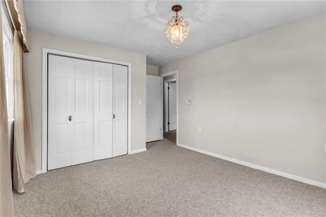 626 Solomon Temple Rd, Unity Twp, PA 15650 - unfurnished bedroom with carpet floors, a closet, and a chandelier