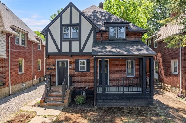 1313 Ingham St, Marshall Shadeland, PA 15212 - tudor-style house featuring roof with shingles, stucco siding, brick siding, a porch, and a chimney