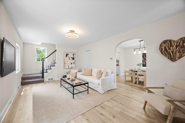 1313 Ingham St, Marshall Shadeland, PA 15212 - living room with arched walkways, light wood-type flooring, and stairway