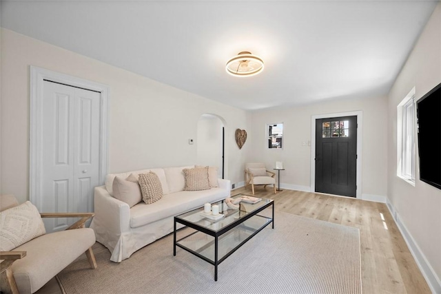 1313 Ingham St, Marshall Shadeland, PA 15212 - living room featuring arched walkways and light wood-style floors