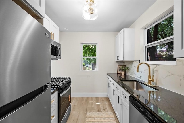 1313 Ingham St, Marshall Shadeland, PA 15212 - kitchen featuring appliances with stainless steel finishes, light wood finished floors, backsplash, and dark stone countertops