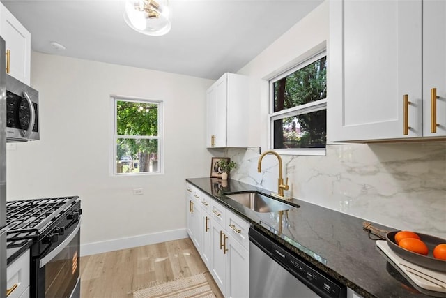 1313 Ingham St, Marshall Shadeland, PA 15212 - kitchen featuring stainless steel appliances, light wood finished floors, backsplash, and dark stone countertops
