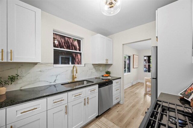 1313 Ingham St, Marshall Shadeland, PA 15212 - kitchen featuring appliances with stainless steel finishes, white cabinets, decorative backsplash, dark stone countertops, and light wood-style floors