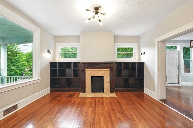 7504 Brighton Rd, Ben Avon, PA 15202 - unfurnished living room featuring hardwood / wood-style flooring, plenty of natural light, and a chandelier