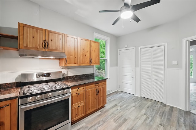 7504 Brighton Rd, Ben Avon, PA 15202 - kitchen with gas range, under cabinet range hood, light wood-style flooring, a ceiling fan, and wainscoting