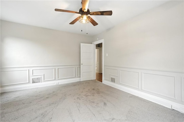 7504 Brighton Rd, Ben Avon, PA 15202 - spare room with carpet, a decorative wall, a ceiling fan, and a wainscoted wall