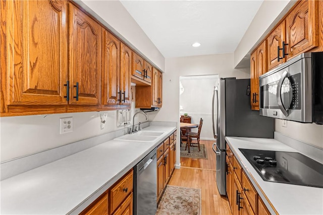 5 Robin Dr, South Strabane, PA 15301 - kitchen with stainless steel appliances, brown cabinetry, light countertops, and recessed lighting