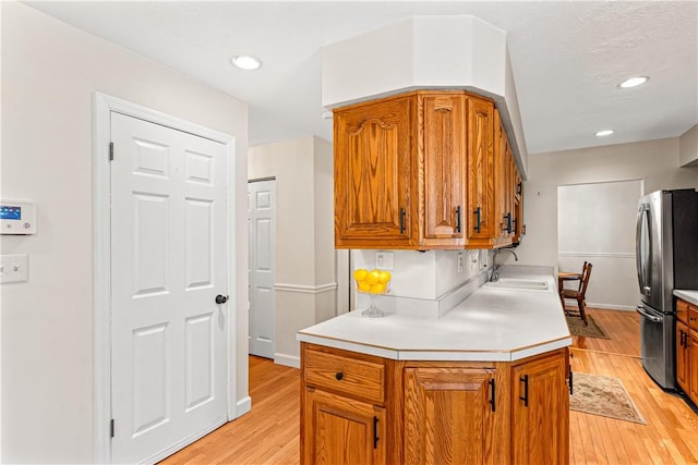 5 Robin Dr, South Strabane, PA 15301 - kitchen featuring freestanding refrigerator, light wood-style flooring, light countertops, brown cabinetry, and recessed lighting