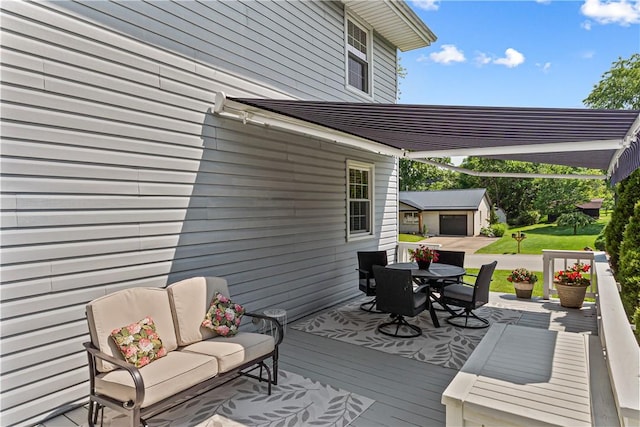 5 Robin Dr, South Strabane, PA 15301 - wooden deck with outdoor dining area, a lawn, and an outdoor structure