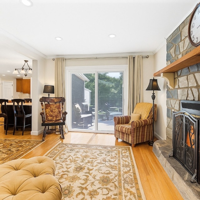 5 Robin Dr, South Strabane, PA 15301 - living area with crown molding, a stone fireplace, light wood-type flooring, a chandelier, and recessed lighting