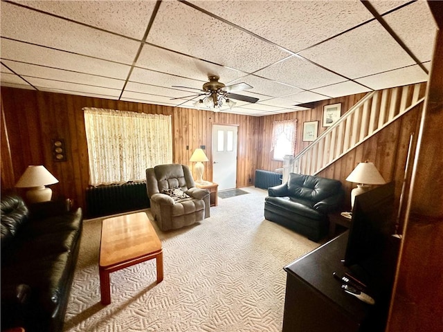 328 N Gallatin Ave, North Union Twp, PA 15401 - carpeted living area with wooden walls, a ceiling fan, a paneled ceiling, and stairway