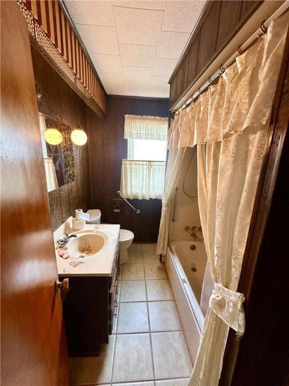 328 N Gallatin Ave, North Union Twp, PA 15401 - full bathroom featuring vanity, shower / tub combo, wood walls, and tile patterned floors
