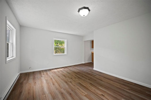 1153 Robinson Hwy, Robinson Twp Wsh, PA 15057 - empty room featuring a baseboard heating unit and wood finished floors