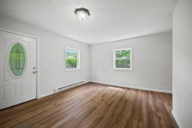 1153 Robinson Hwy, Robinson Twp Wsh, PA 15057 - foyer entrance featuring baseboard heating, wood finished floors, and a textured ceiling