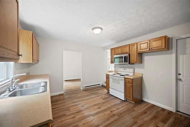 1153 Robinson Hwy, Robinson Twp Wsh, PA 15057 - kitchen featuring stainless steel microwave, white electric stove, light wood-style floors, a baseboard radiator, and light countertops