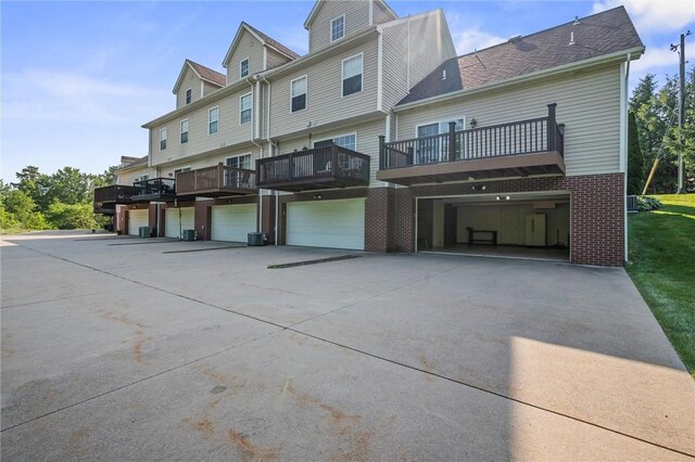 101 Creekside Dr, Buffalo Twp, PA 16055 - back of property with an attached garage, driveway, brick siding, and a balcony