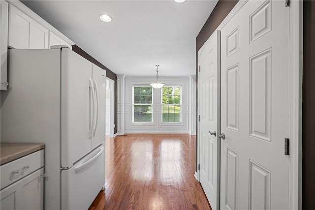 101 Creekside Dr, Buffalo Twp, PA 16055 - kitchen featuring freestanding refrigerator, dark wood-style floors, white cabinets, recessed lighting, and hanging light fixtures