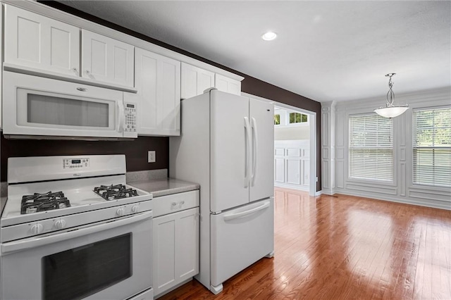 101 Creekside Dr, Buffalo Twp, PA 16055 - kitchen with white appliances, wood finished floors, light countertops, white cabinetry, and pendant lighting