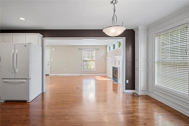 101 Creekside Dr, Buffalo Twp, PA 16055 - unfurnished living room featuring light wood-style floors, a fireplace with flush hearth, and recessed lighting
