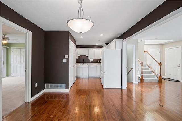 101 Creekside Dr, Buffalo Twp, PA 16055 - kitchen featuring freestanding refrigerator, white cabinets, wood finished floors, pendant lighting, and a ceiling fan