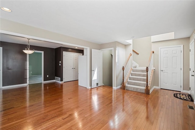 101 Creekside Dr, Buffalo Twp, PA 16055 - unfurnished living room with light wood-style flooring, stairs, and recessed lighting