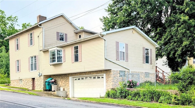 323 E 2nd St, Derry Boro, PA 15627 - view of front of home featuring a garage and a chimney