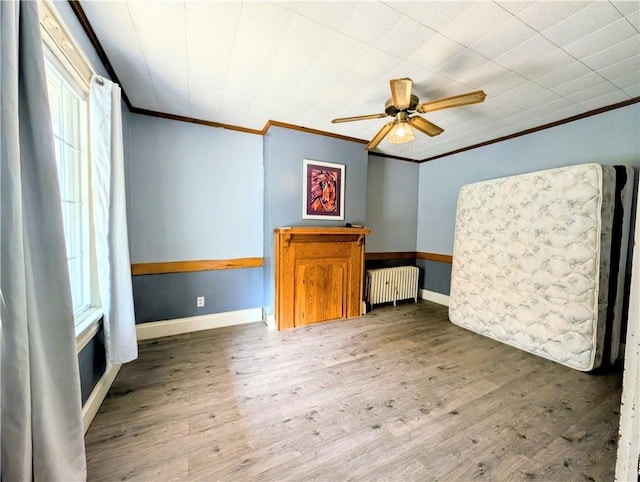323 E 2nd St, Derry Boro, PA 15627 - unfurnished room with radiator, crown molding, plenty of natural light, a ceiling fan, and wood finished floors