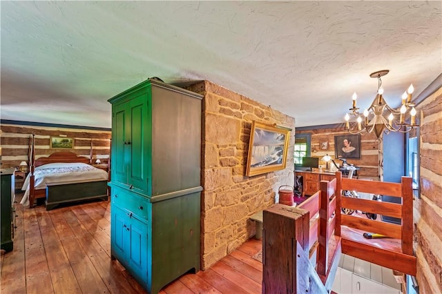 117 Havers Hill Rd, Jefferson/Mather, PA 15344 - corridor with hardwood / wood-style floors, a chandelier, wooden walls, and a textured ceiling