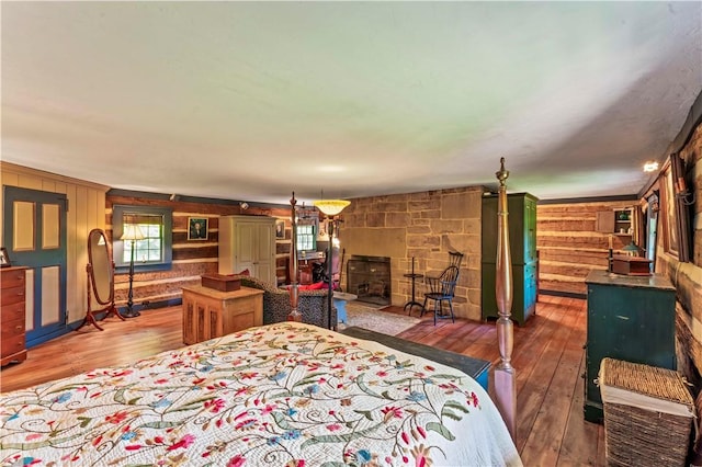 117 Havers Hill Rd, Jefferson/Mather, PA 15344 - bedroom with hardwood / wood-style flooring, a fireplace, and wooden walls