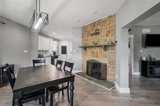 943 State Route 66, Gilpin Twp, PA 15690 - dining space featuring wood finished floors, a stone fireplace, and recessed lighting