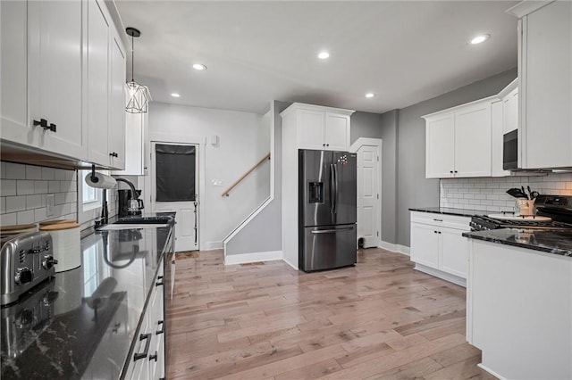 943 State Route 66, Gilpin Twp, PA 15690 - kitchen featuring stainless steel fridge, range, tasteful backsplash, white cabinets, and recessed lighting
