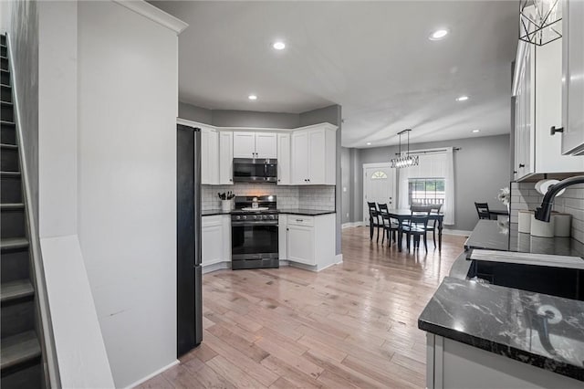 943 State Route 66, Gilpin Twp, PA 15690 - kitchen with stainless steel appliances, decorative backsplash, recessed lighting, white cabinetry, and light wood-type flooring
