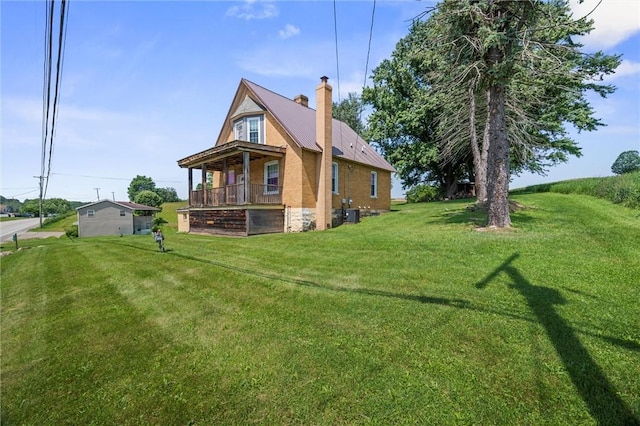 943 State Route 66, Gilpin Twp, PA 15690 - back of property featuring a lawn, a chimney, and a metal roof