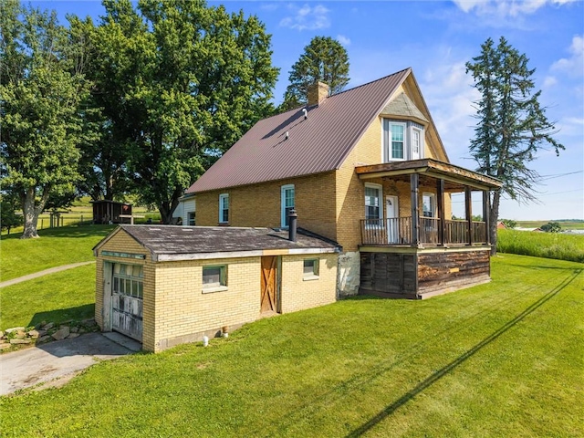 943 State Route 66, Gilpin Twp, PA 15690 - rear view of property featuring brick siding, a chimney, a lawn, and a metal roof