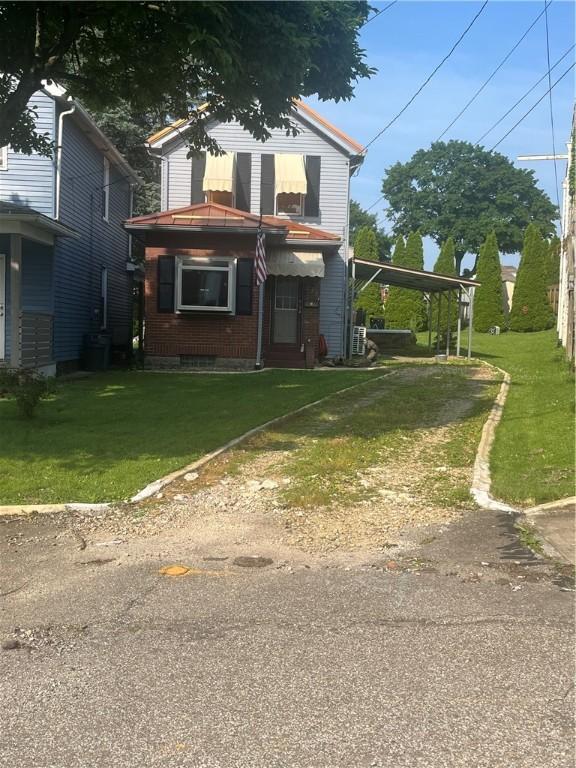 223 Hoeveler, Springdale Boro, PA 15144 - view of front of house featuring a front yard, driveway, and a carport