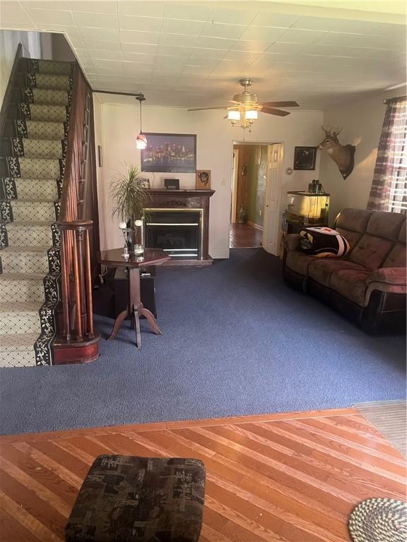 223 Hoeveler, Springdale Boro, PA 15144 - living room with stairs, carpet flooring, a glass covered fireplace, and ceiling fan
